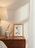 Funny Raccoon Cocktail Art art print shown in a small bedside oak setting