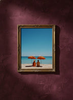 Couple Beach Umbrella Art art print shown in a burgundy brass setting