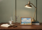 Vintage Summer Beach Scene Art art print shown in a small desk oak setting