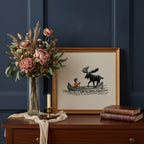 Boy and Moose Canoe Art art print shown in a dresser dried florals setting