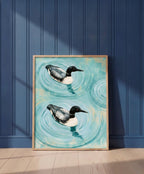 Common Loon Pair Painting art print shown in a blue wall paneled setting