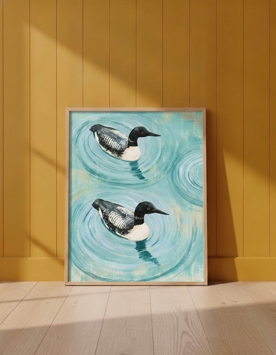 Common Loon Pair Painting art print shown in a yellow wall setting
